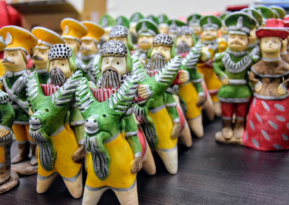 a group of ceramic figurines of people dressed in costumes