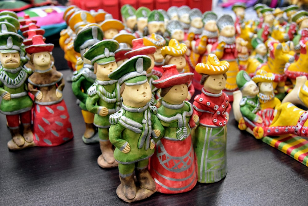 a group of ceramic figurines of different colors and sizes