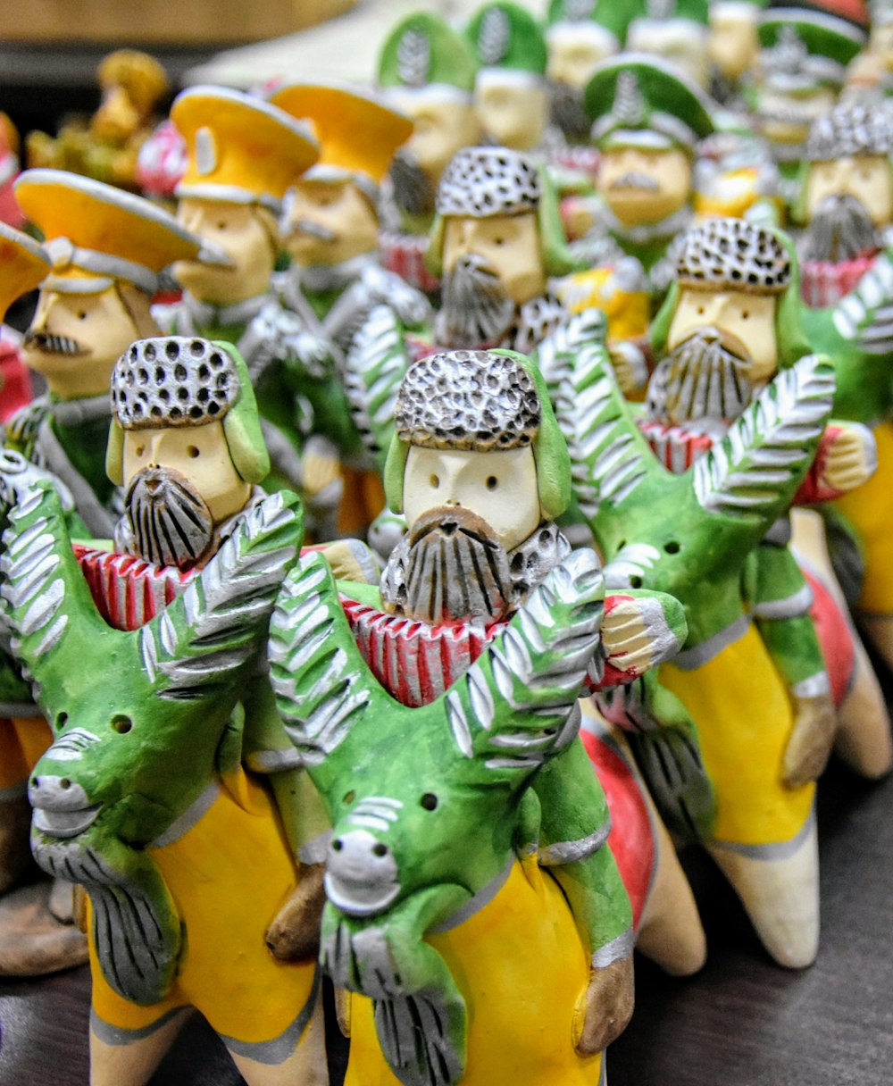 a group of ceramic figurines of men riding horses