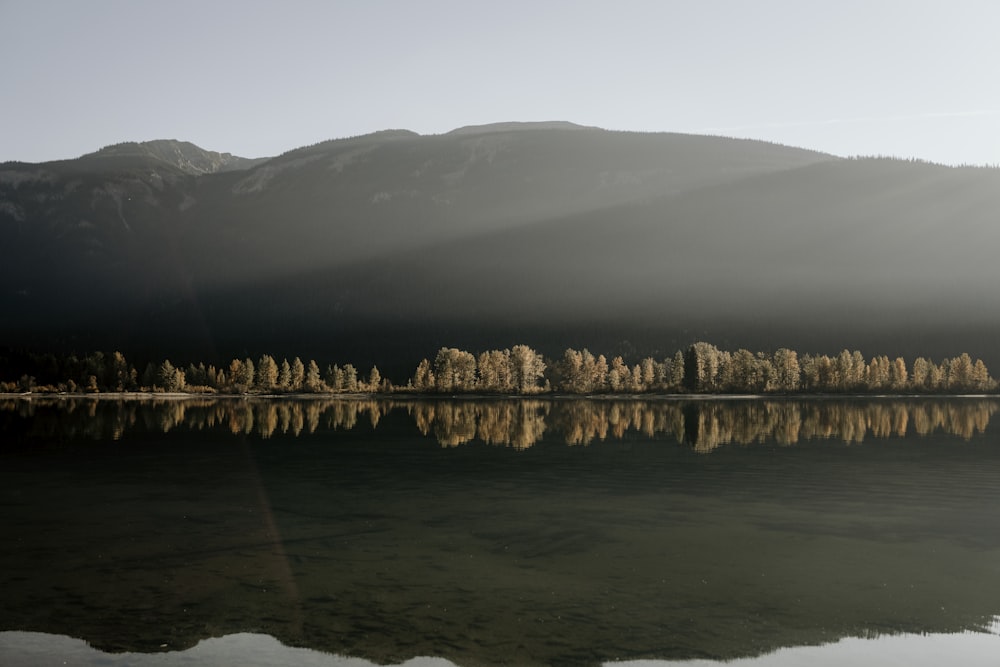 a body of water with a mountain in the background