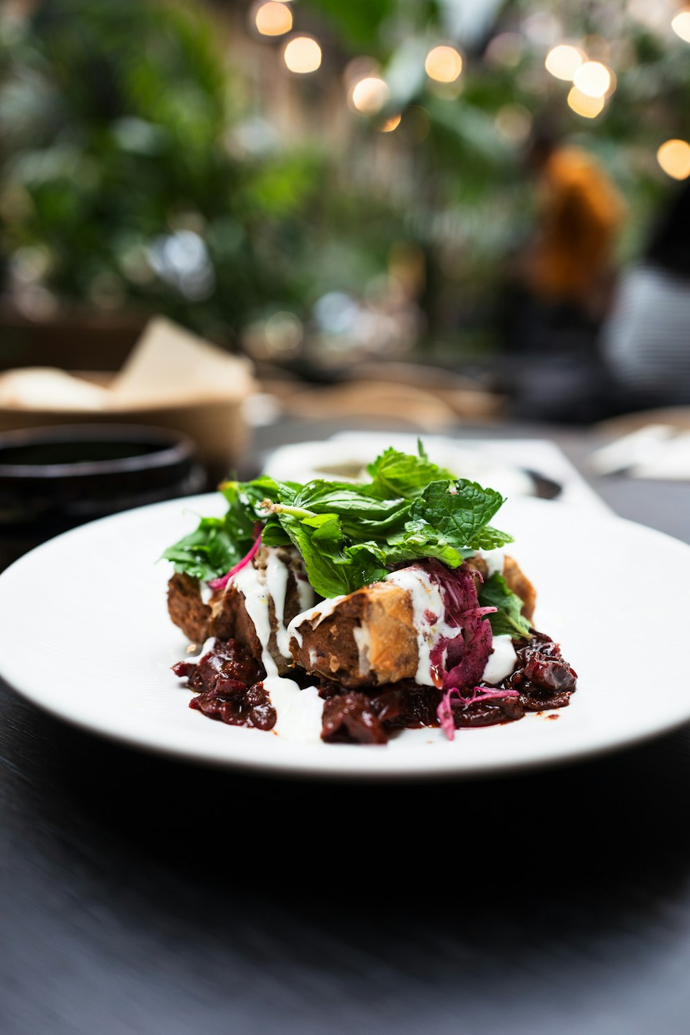 a white plate topped with meat and greens