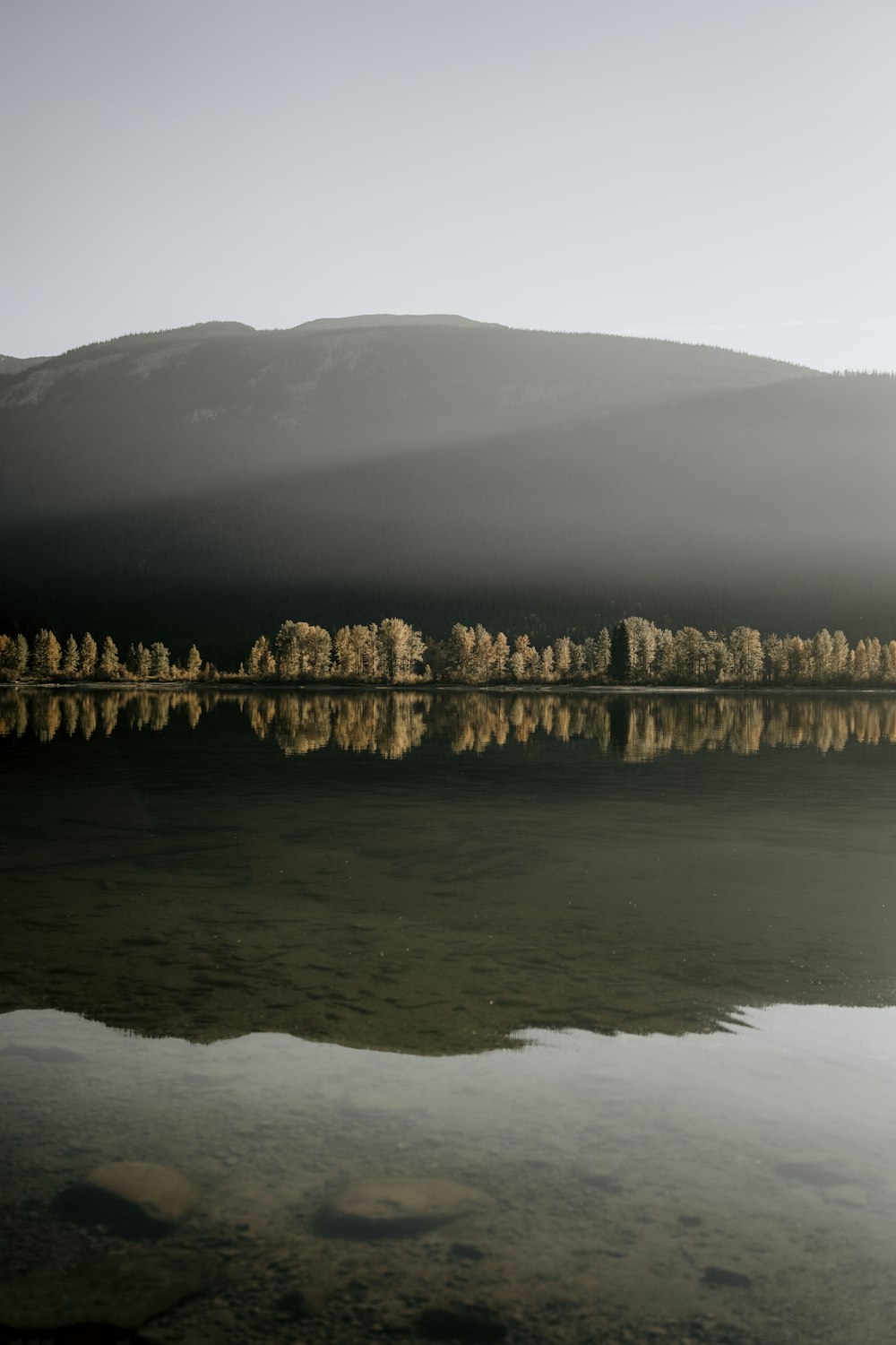 a body of water with a mountain in the background