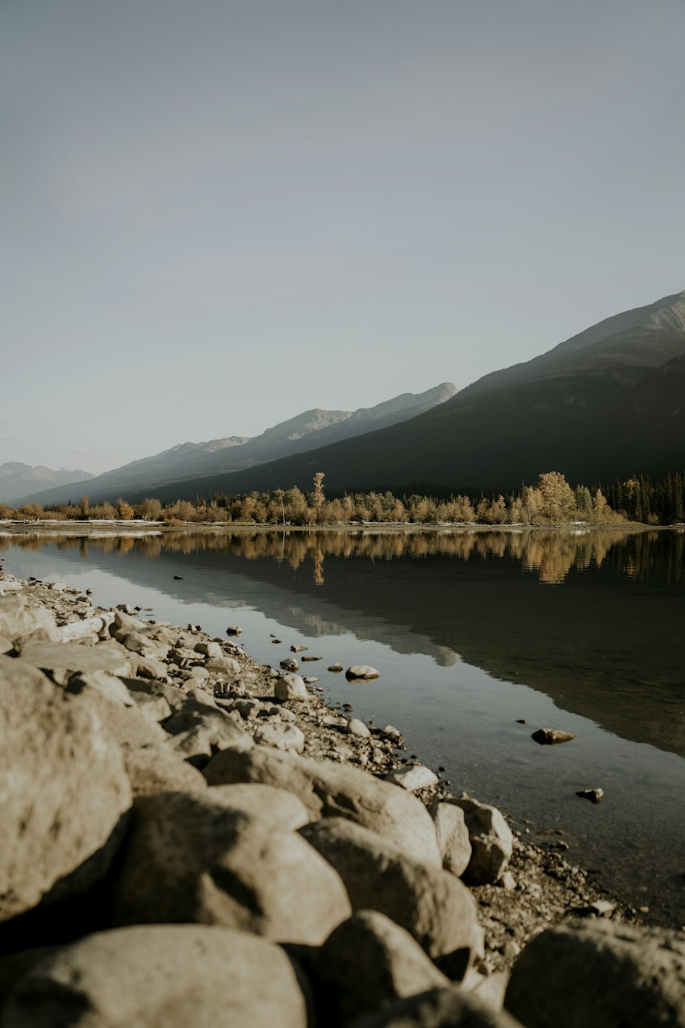 a body of water surrounded by rocks and mountains