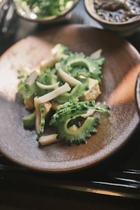a plate of broccoli and other vegetables on a table