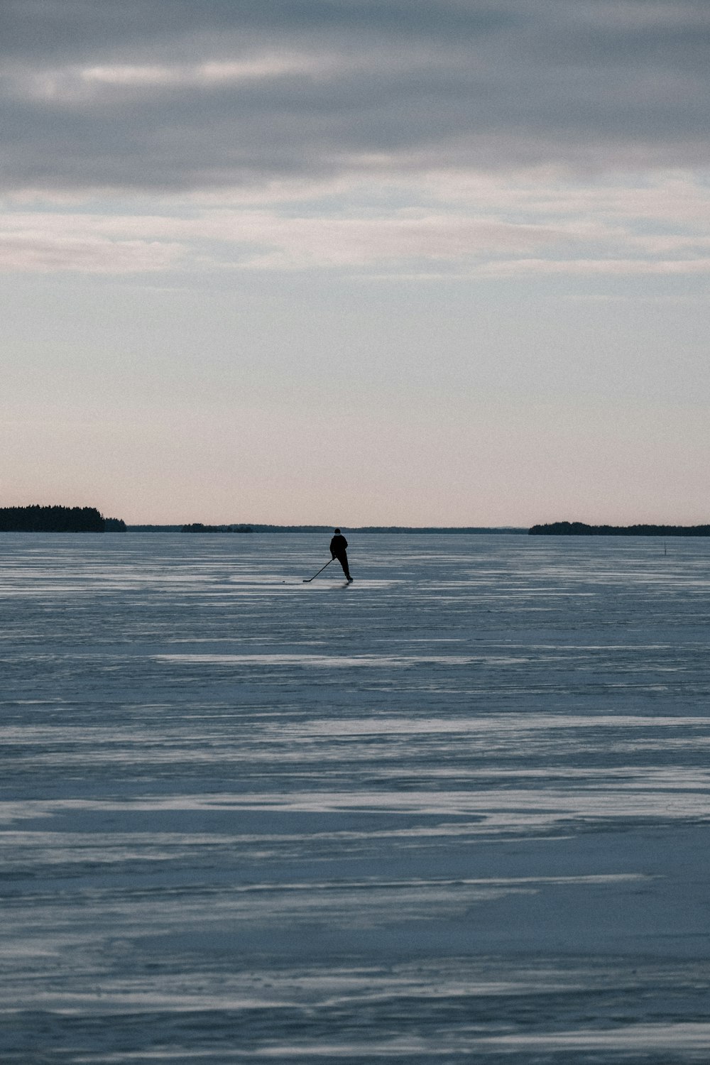 a person standing on a surfboard in the middle of the ocean