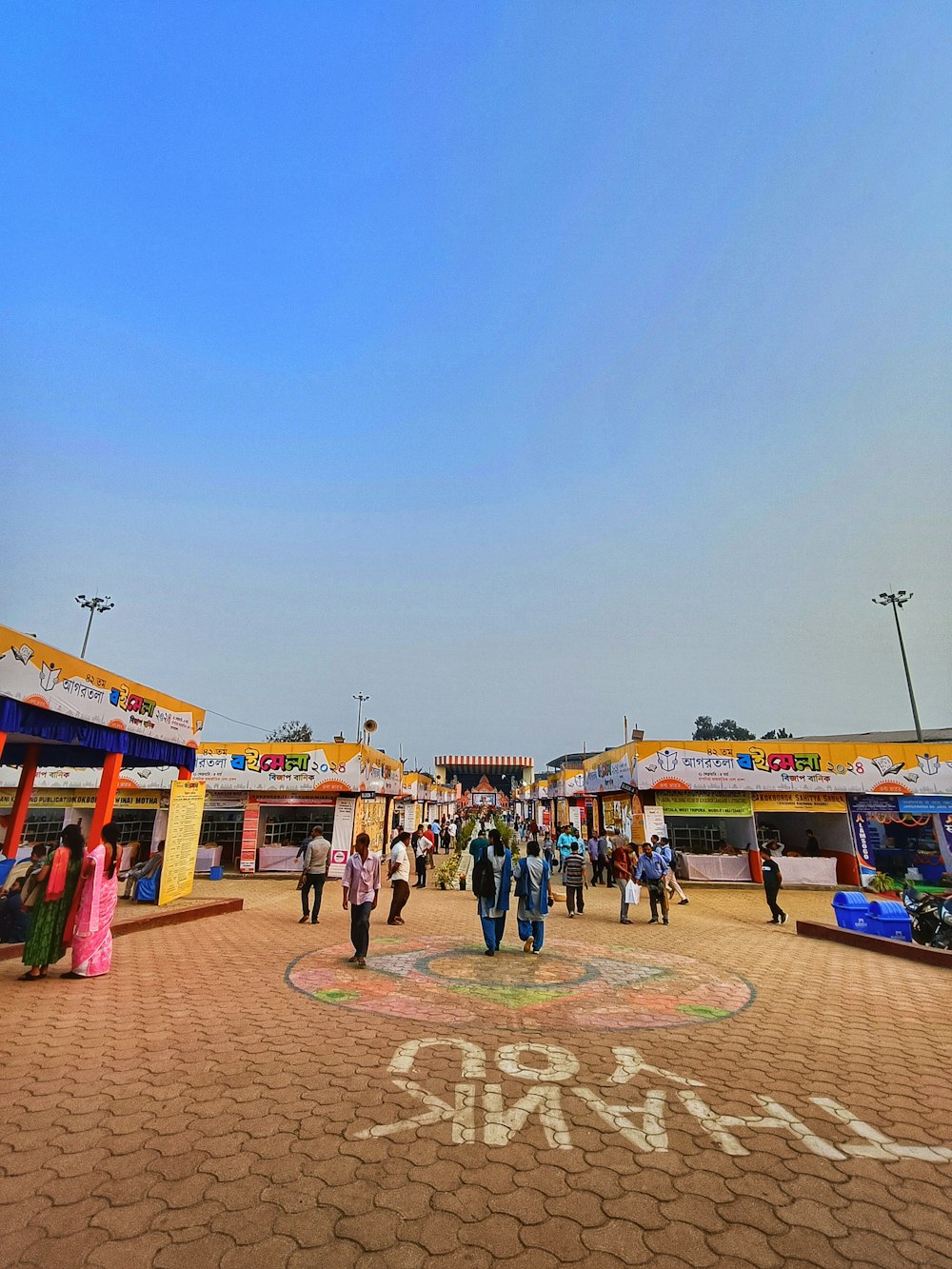 a group of people walking around a carnival