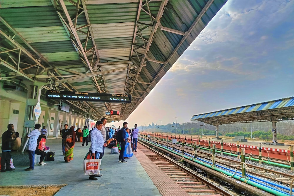 a group of people standing at a train station