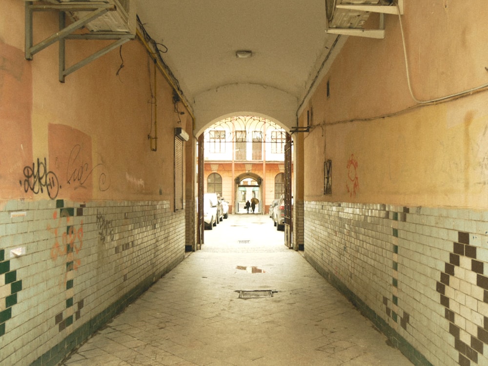 a long hallway with graffiti on the walls