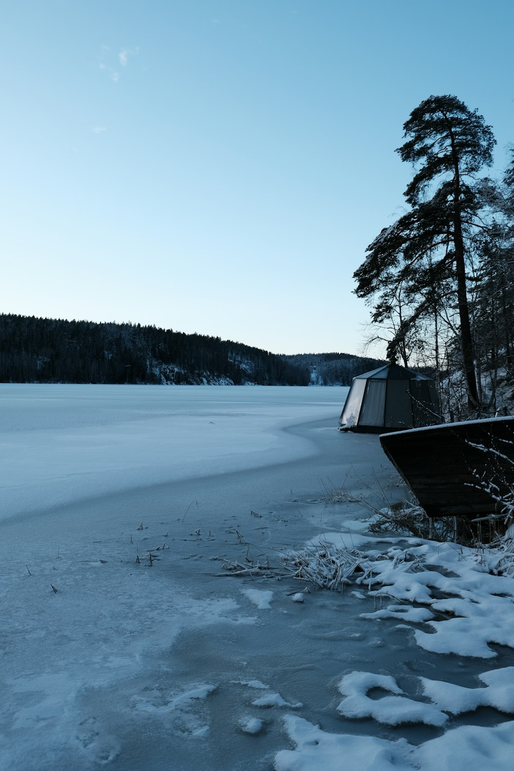 a boat sitting on top of a frozen lake
