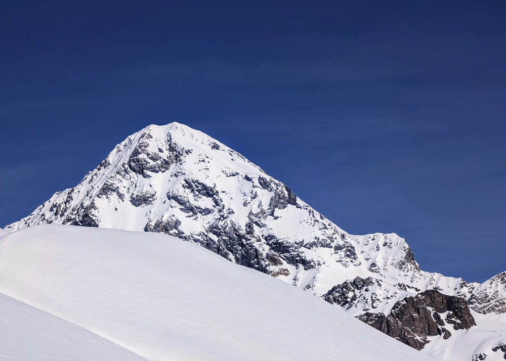 a snow covered mountain with a clear blue sky