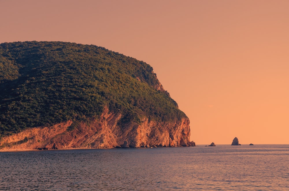 a large rock in the middle of a body of water