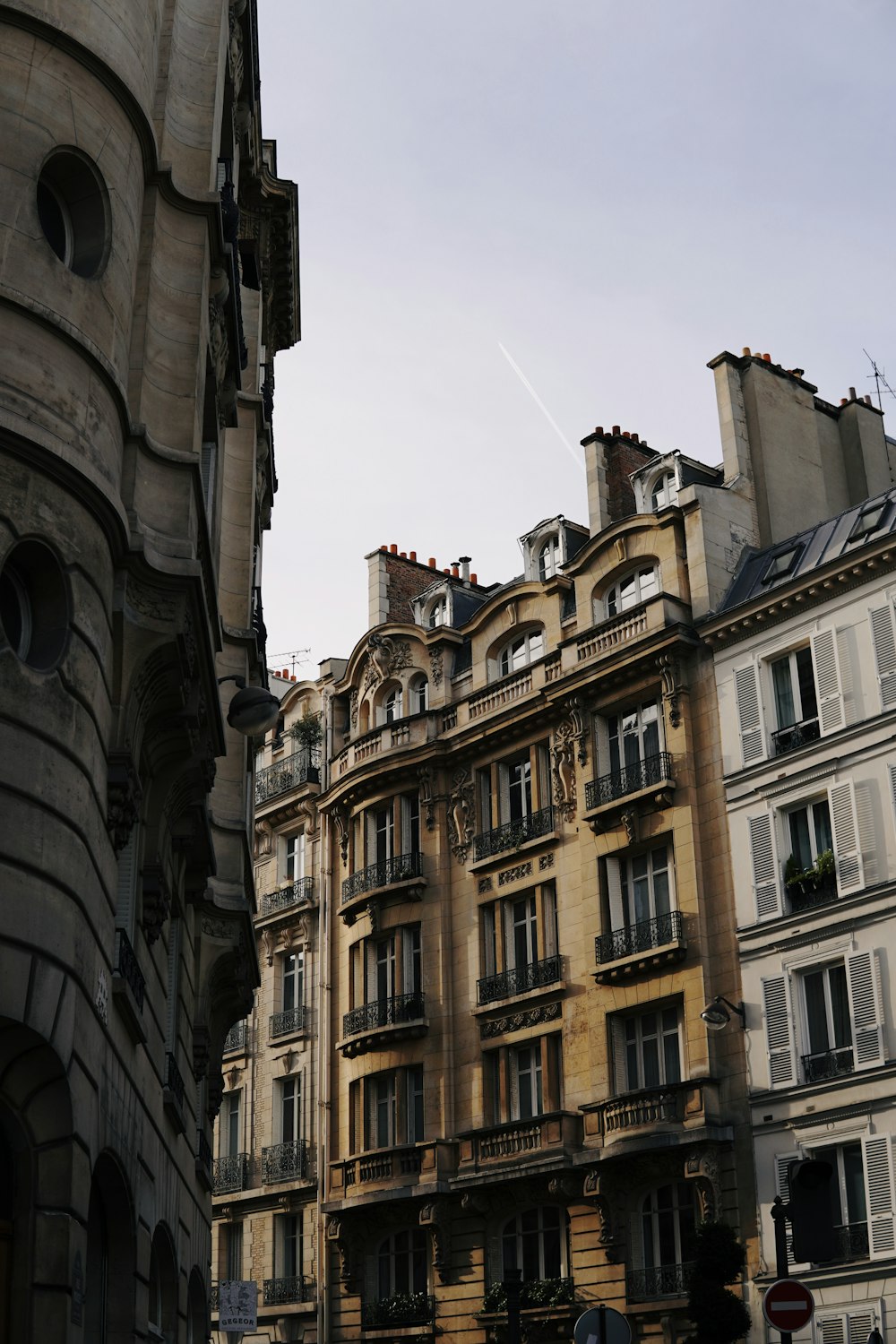 a city street with tall buildings and a traffic light