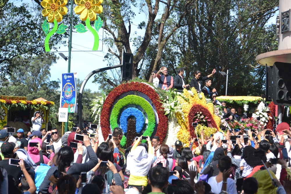 a group of people standing around a float in a parade