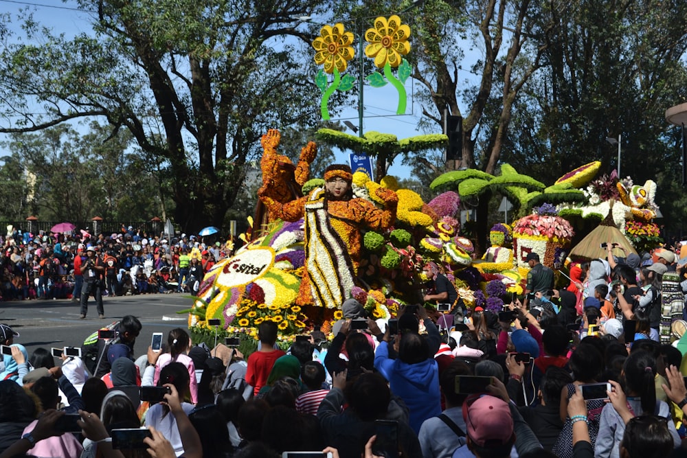 a group of people standing around a float in a parade