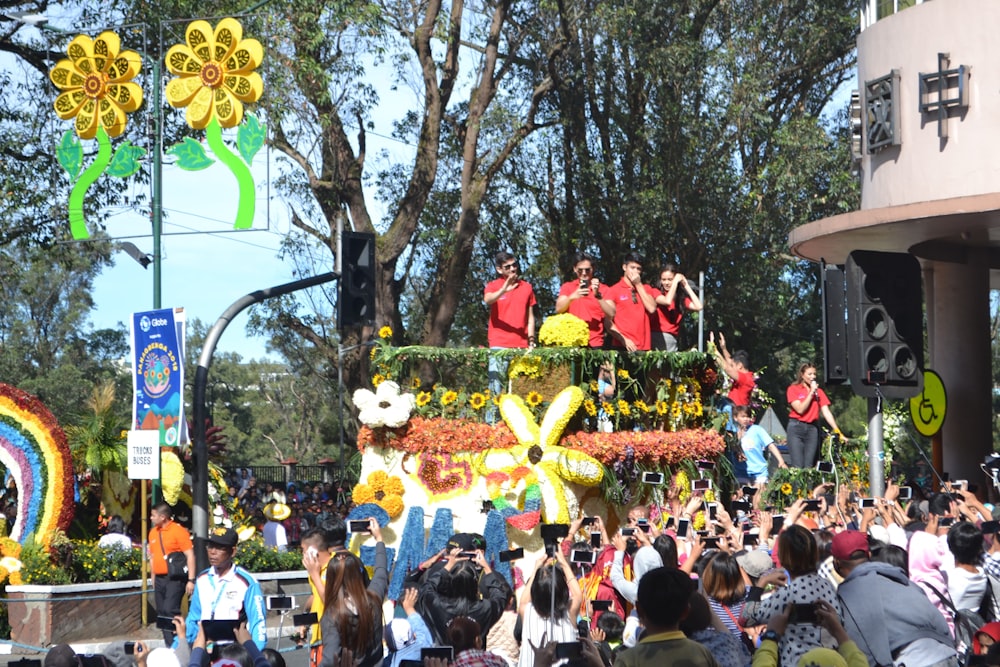 a group of people standing on top of a float