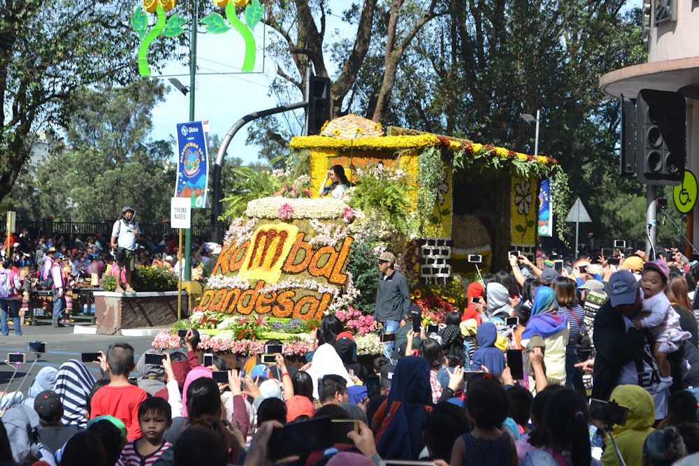 a parade float with people walking around it