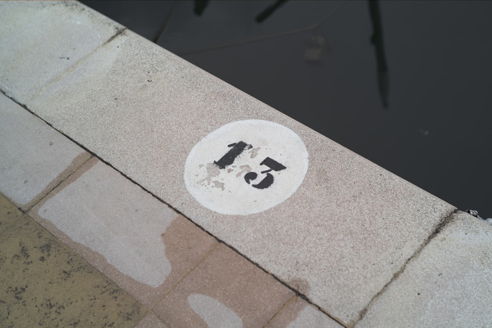 a street sign on a sidewalk next to a body of water