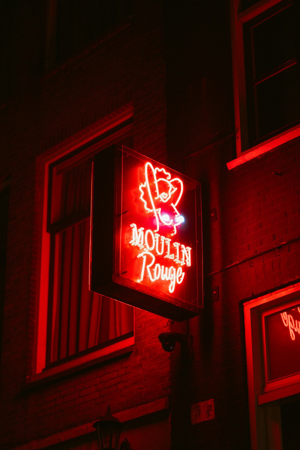 a neon sign is lit up on the side of a building