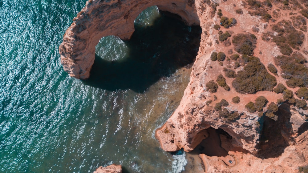 an aerial view of a rock formation in the ocean