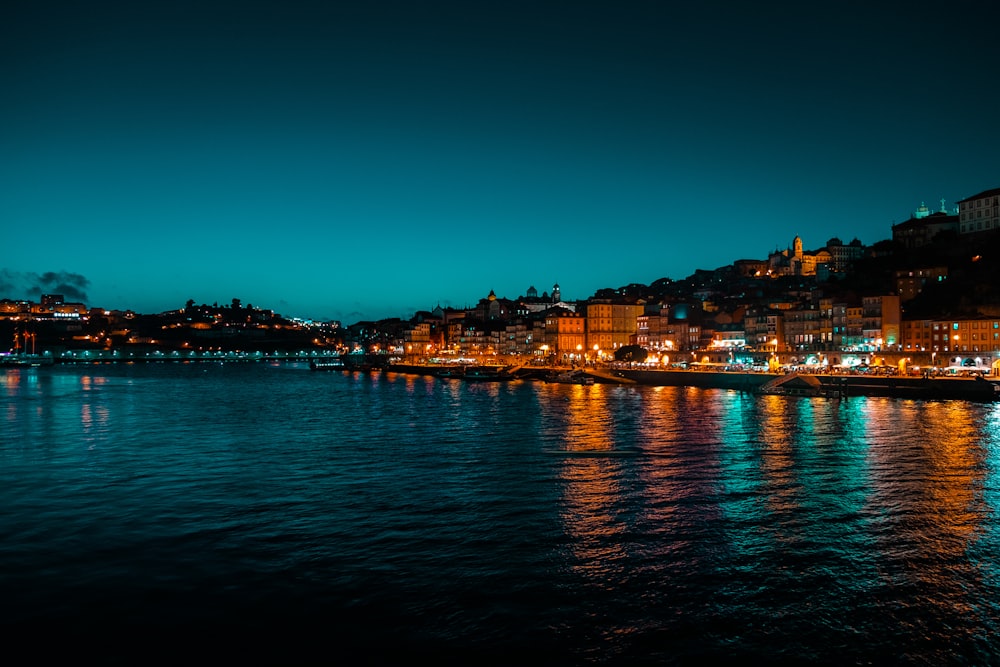 a body of water with a city in the background