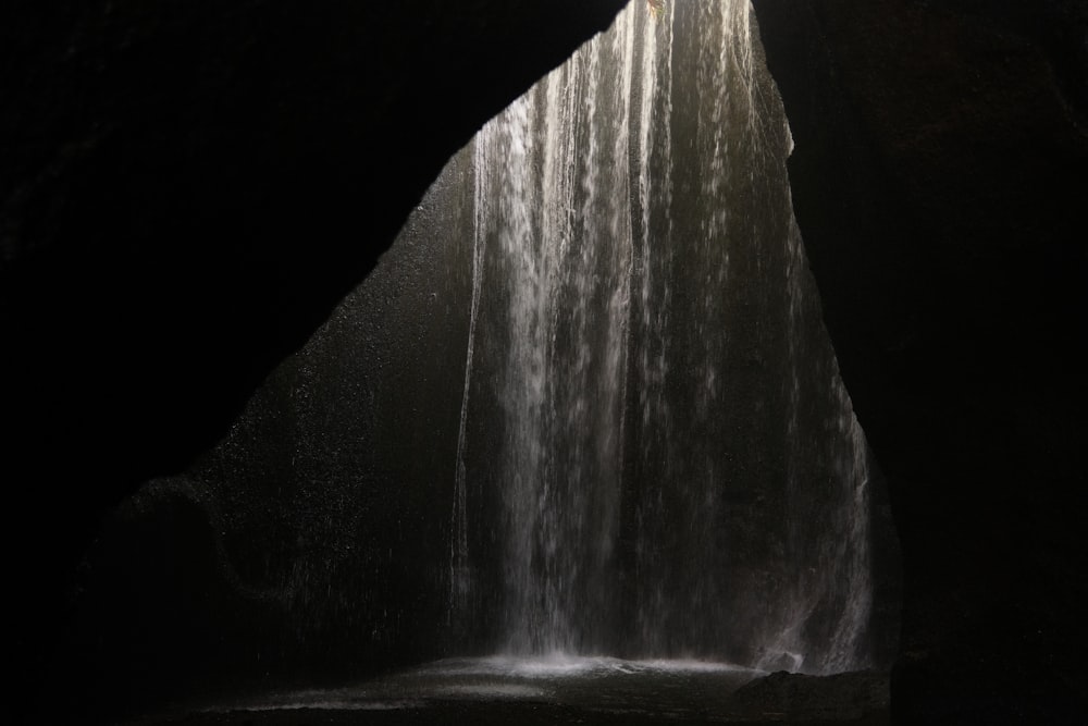 a waterfall with a light coming from the top of it