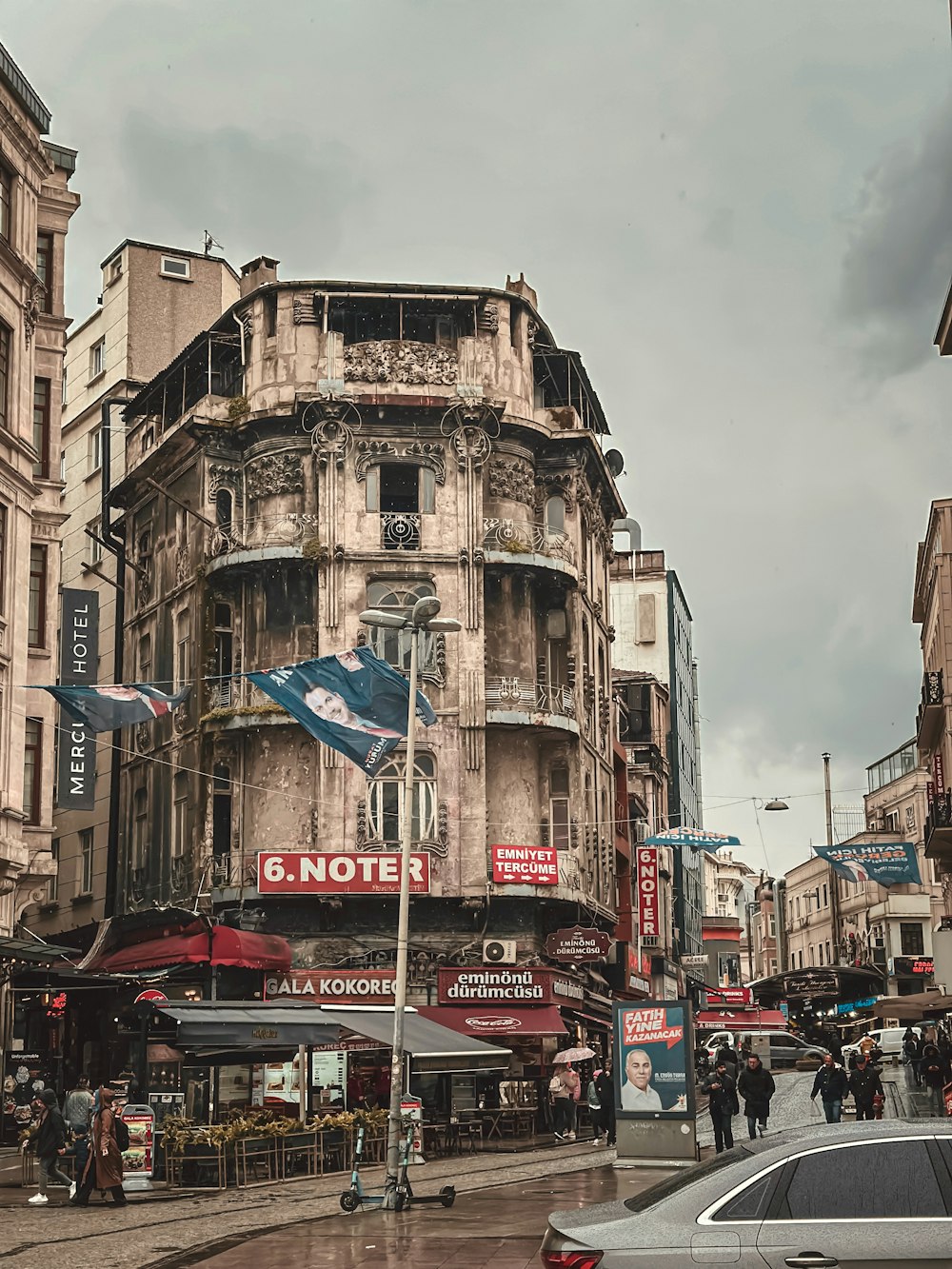 an old building with a flag on a street corner