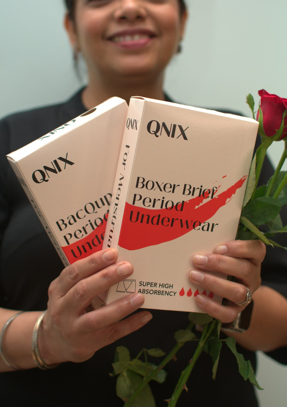 a woman holding two books in her hands