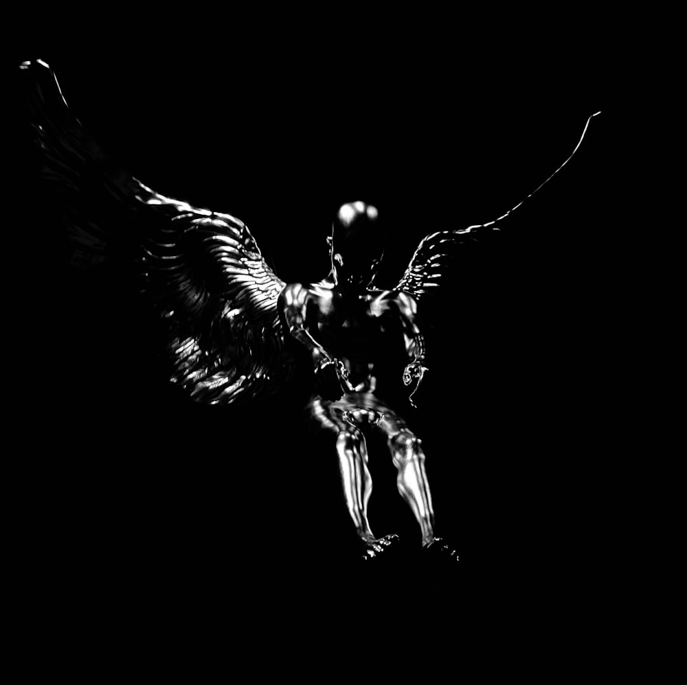 a black and white photo of a flying bird