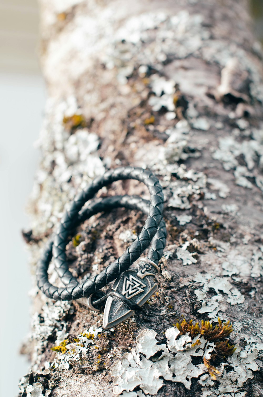 a couple of bracelets sitting on top of a tree