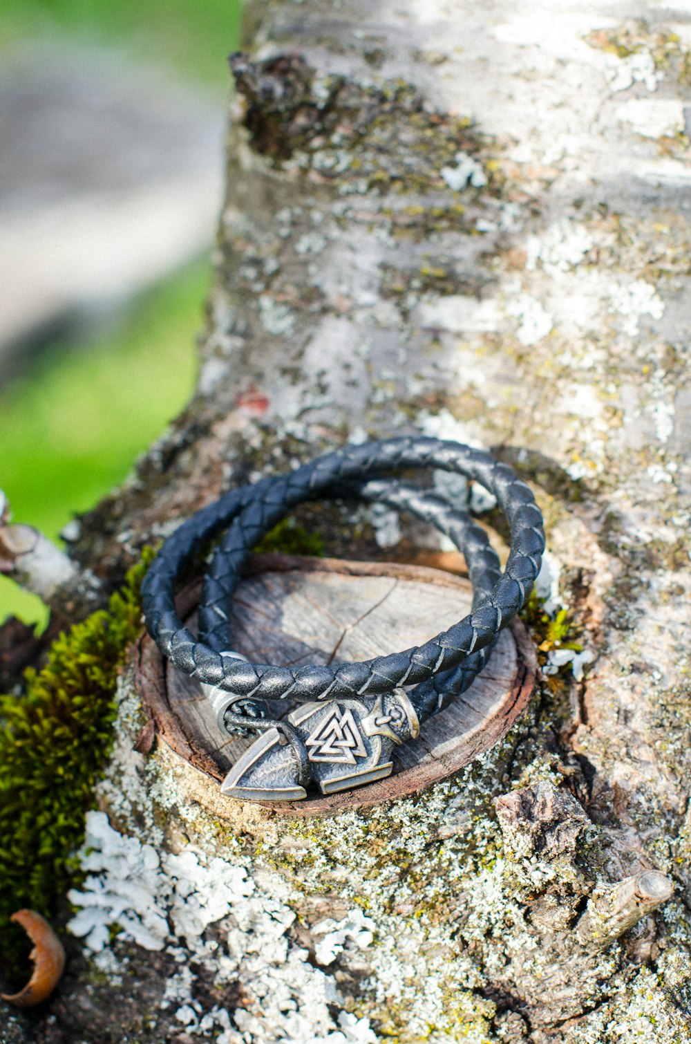 a couple of bracelets sitting on top of a tree