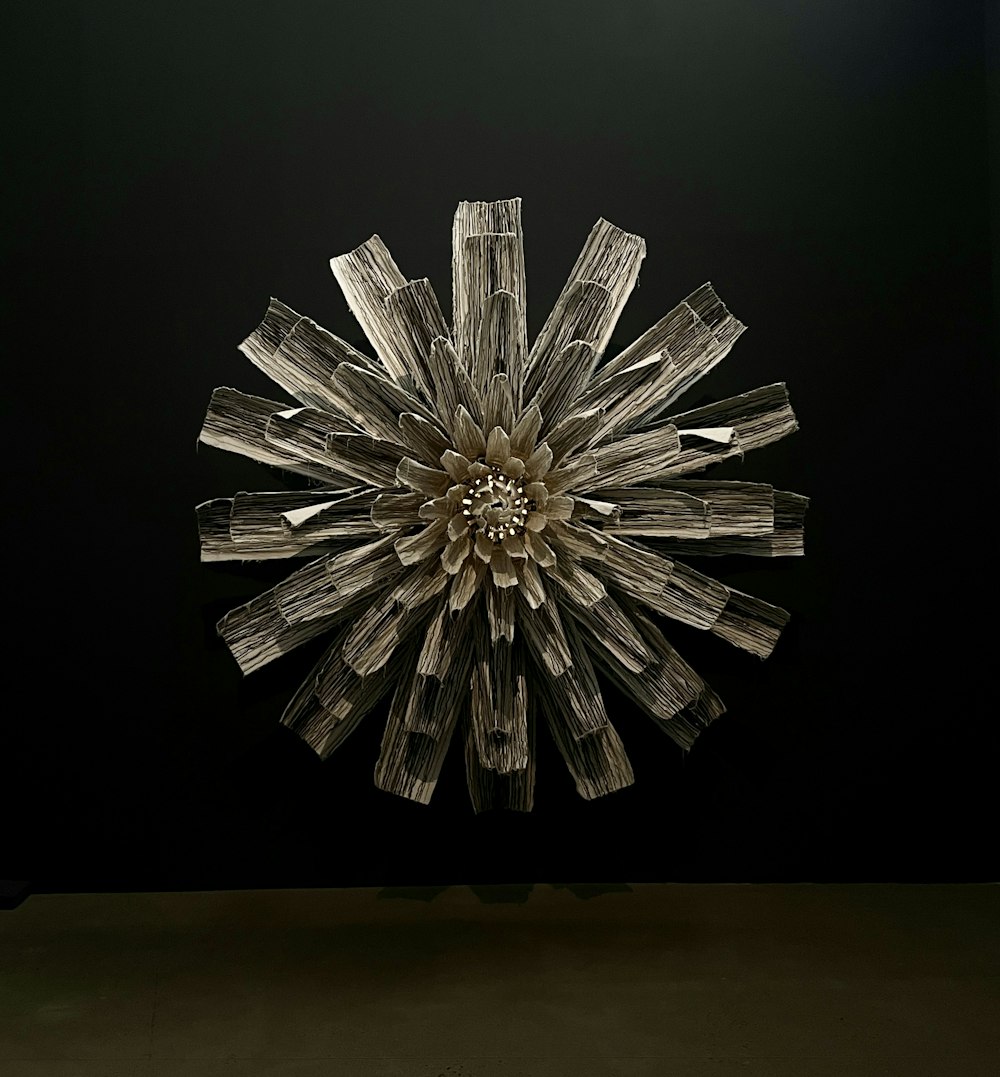 a glass sculpture of a flower on a black background