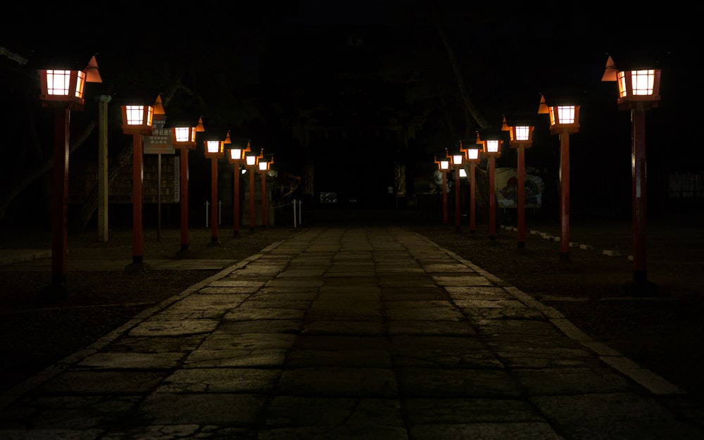 a dark street with some lights on it