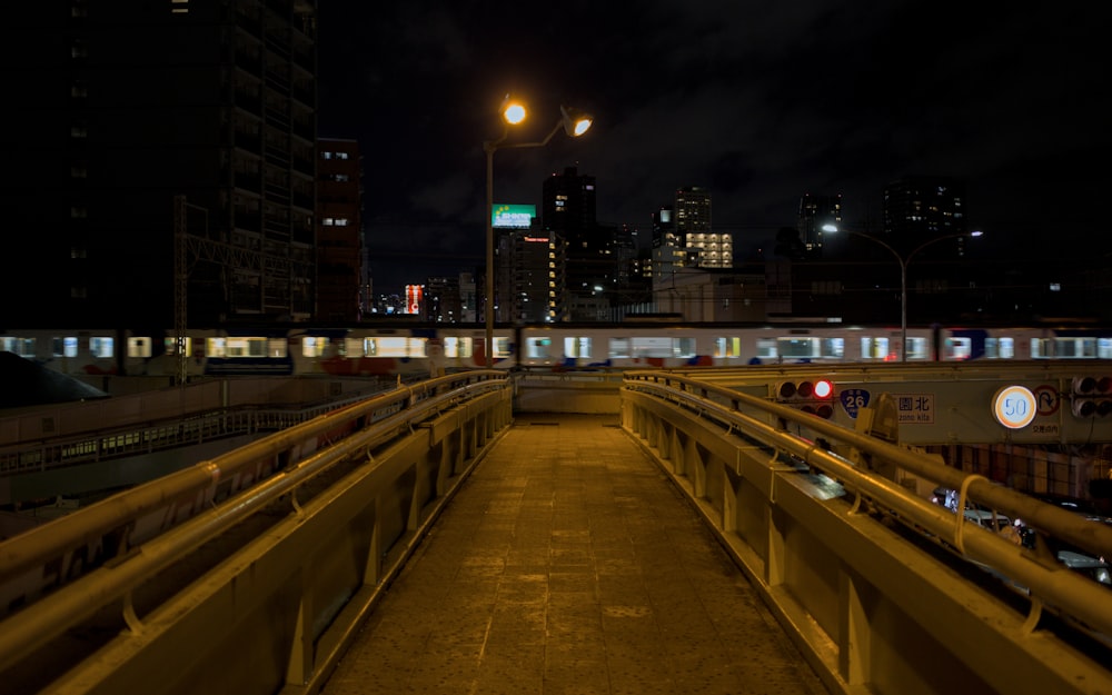 a train traveling over a bridge at night