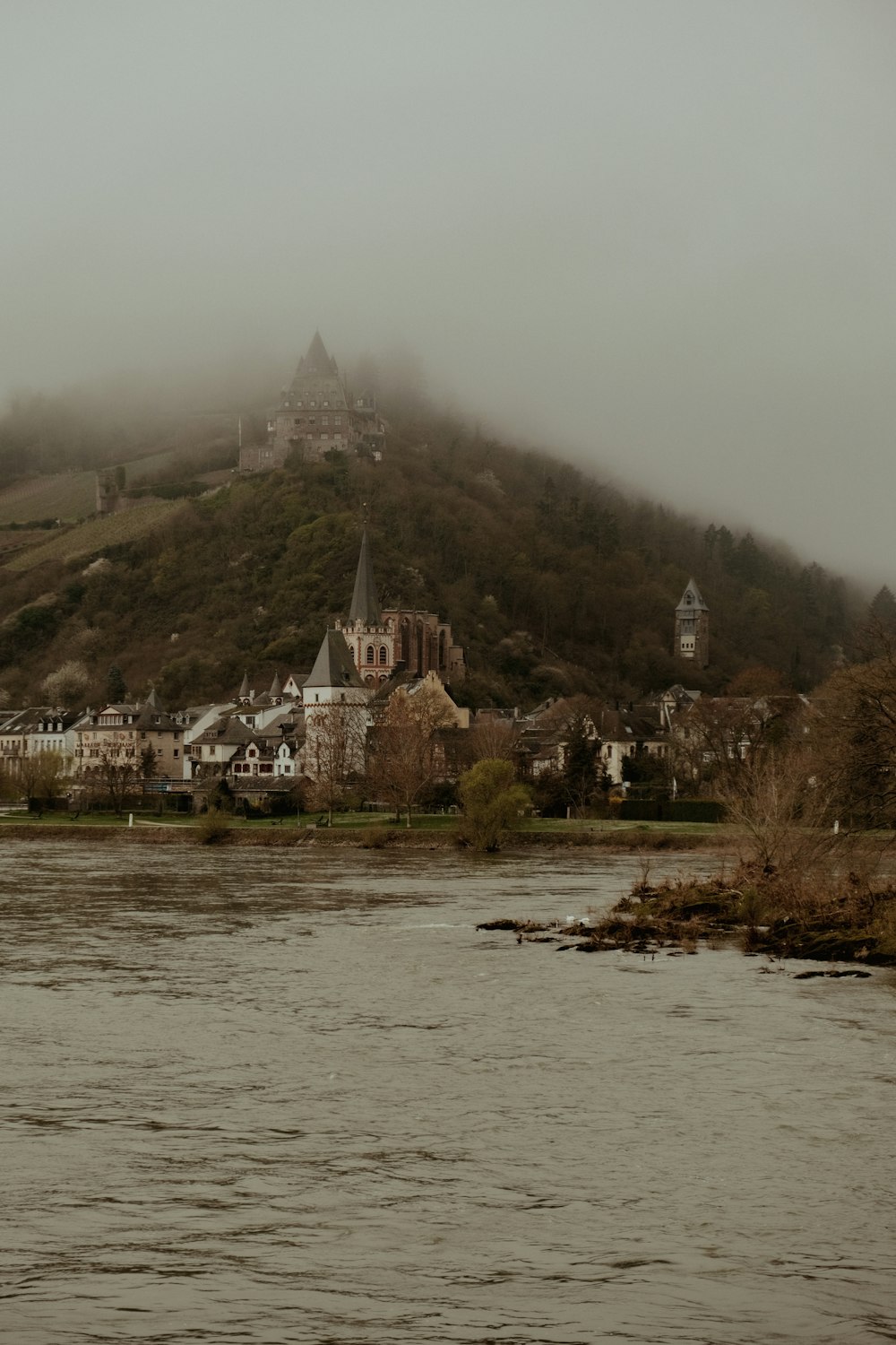 a large body of water with a castle on a hill in the background