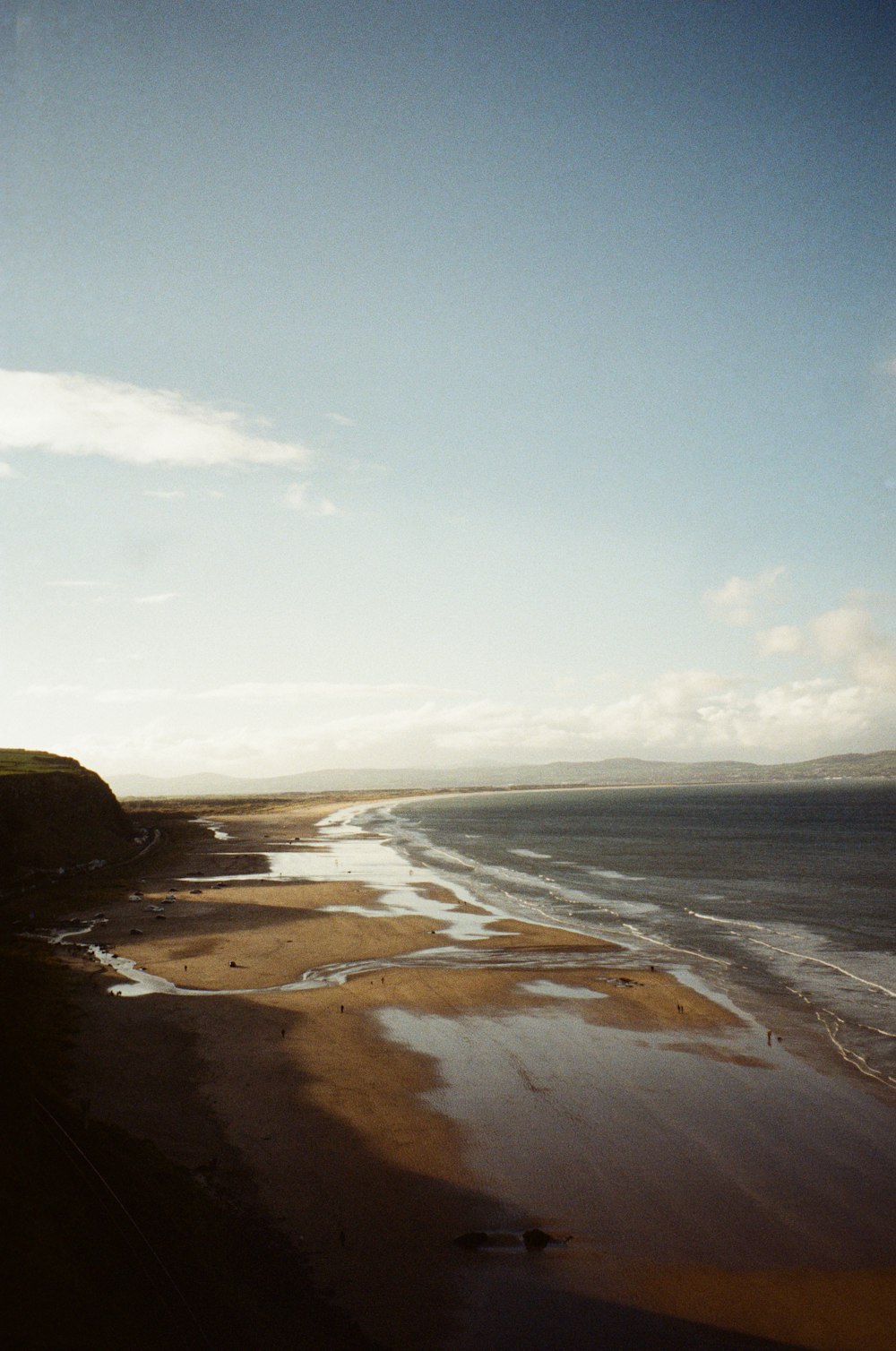 a view of a beach from the top of a hill