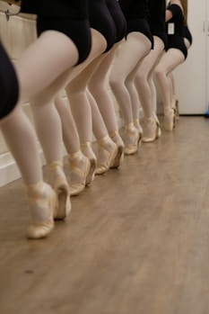 a row of mannequins wearing ballet shoes