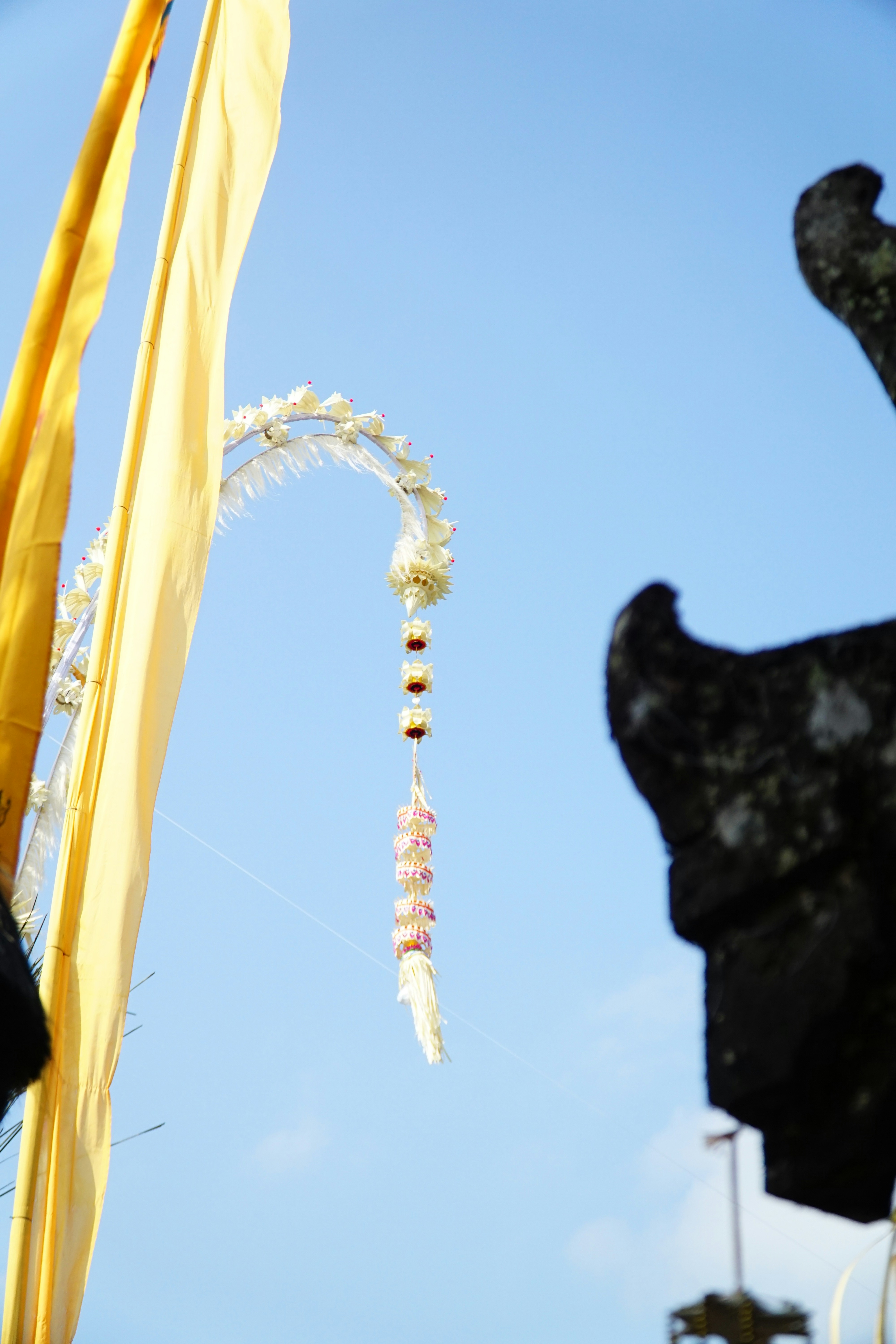 a close up of a kite flying in the sky