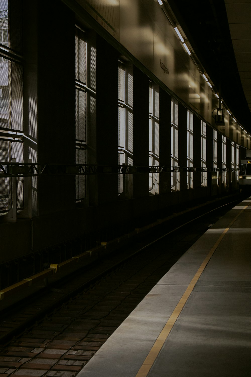 a train station with a train on the tracks