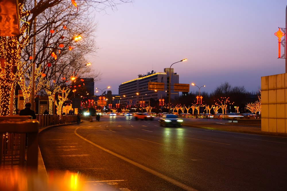 a city street filled with lots of traffic next to tall buildings