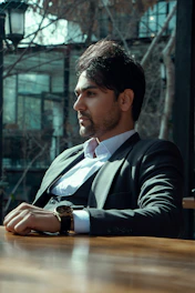 a man in a suit sitting at a table