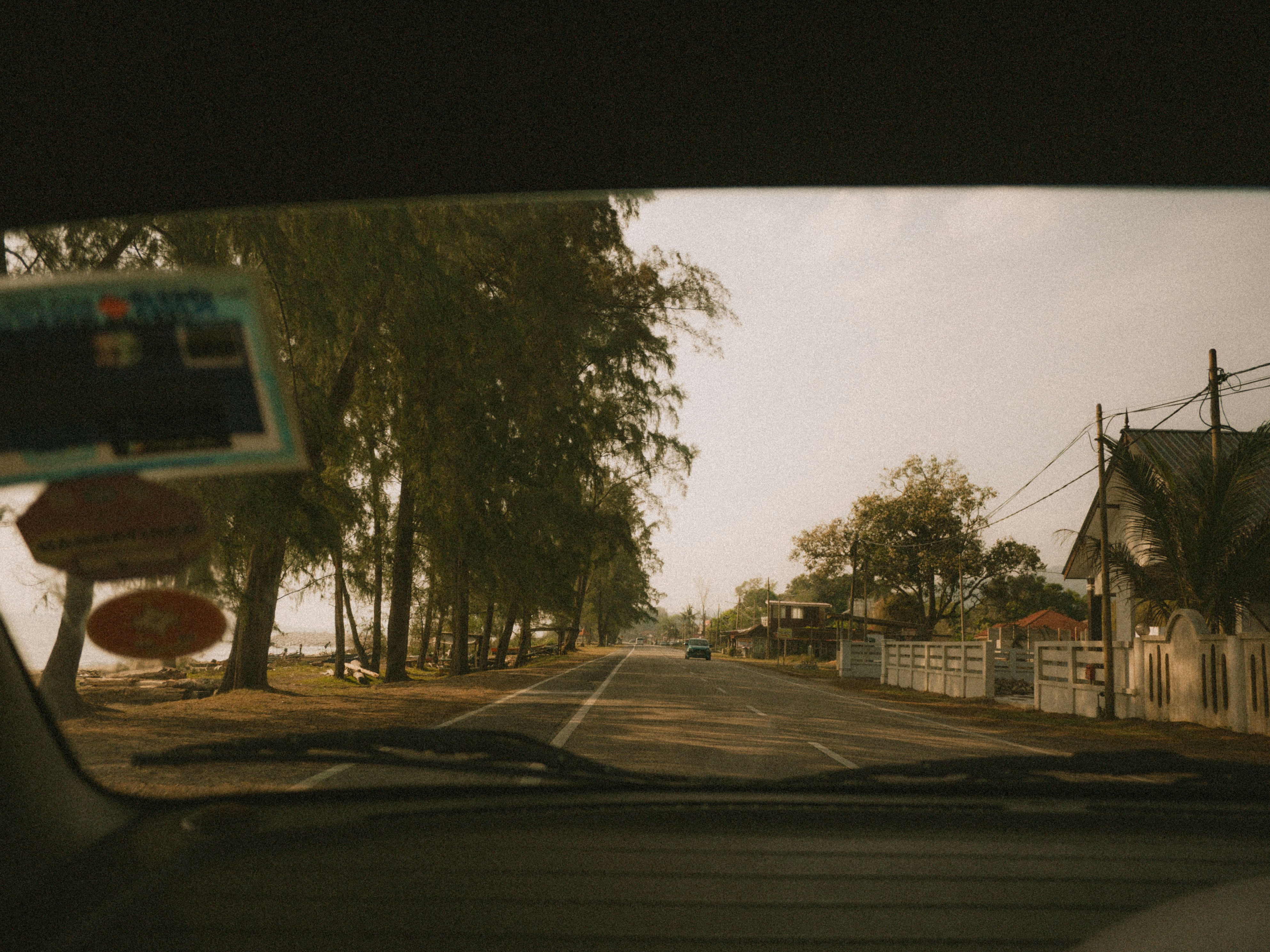 a view of a street from inside a car