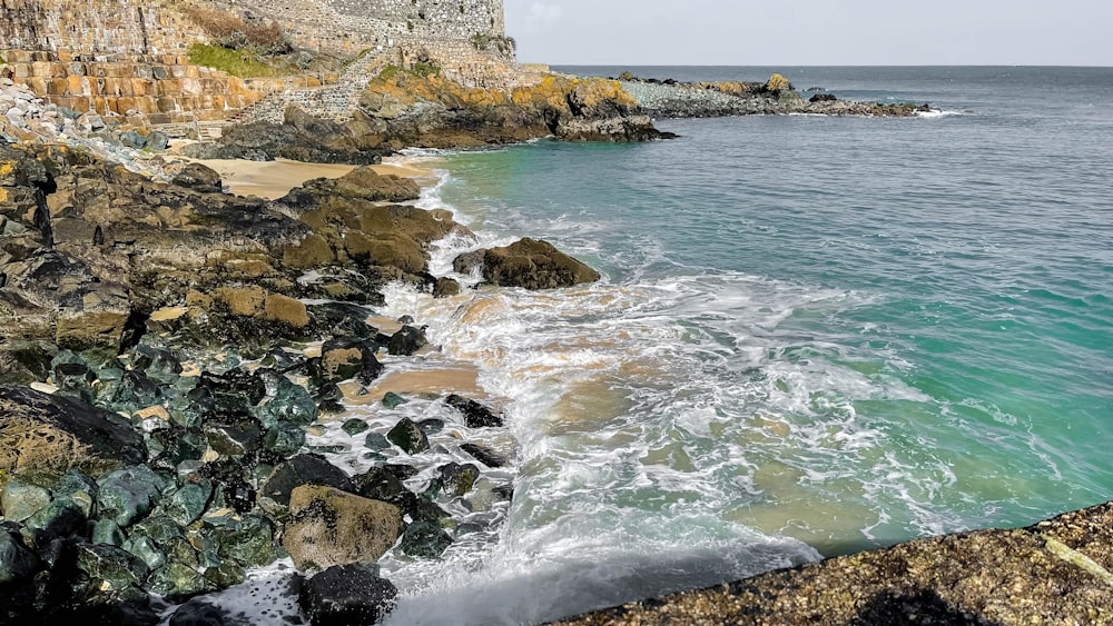 a view of a rocky shore with a body of water