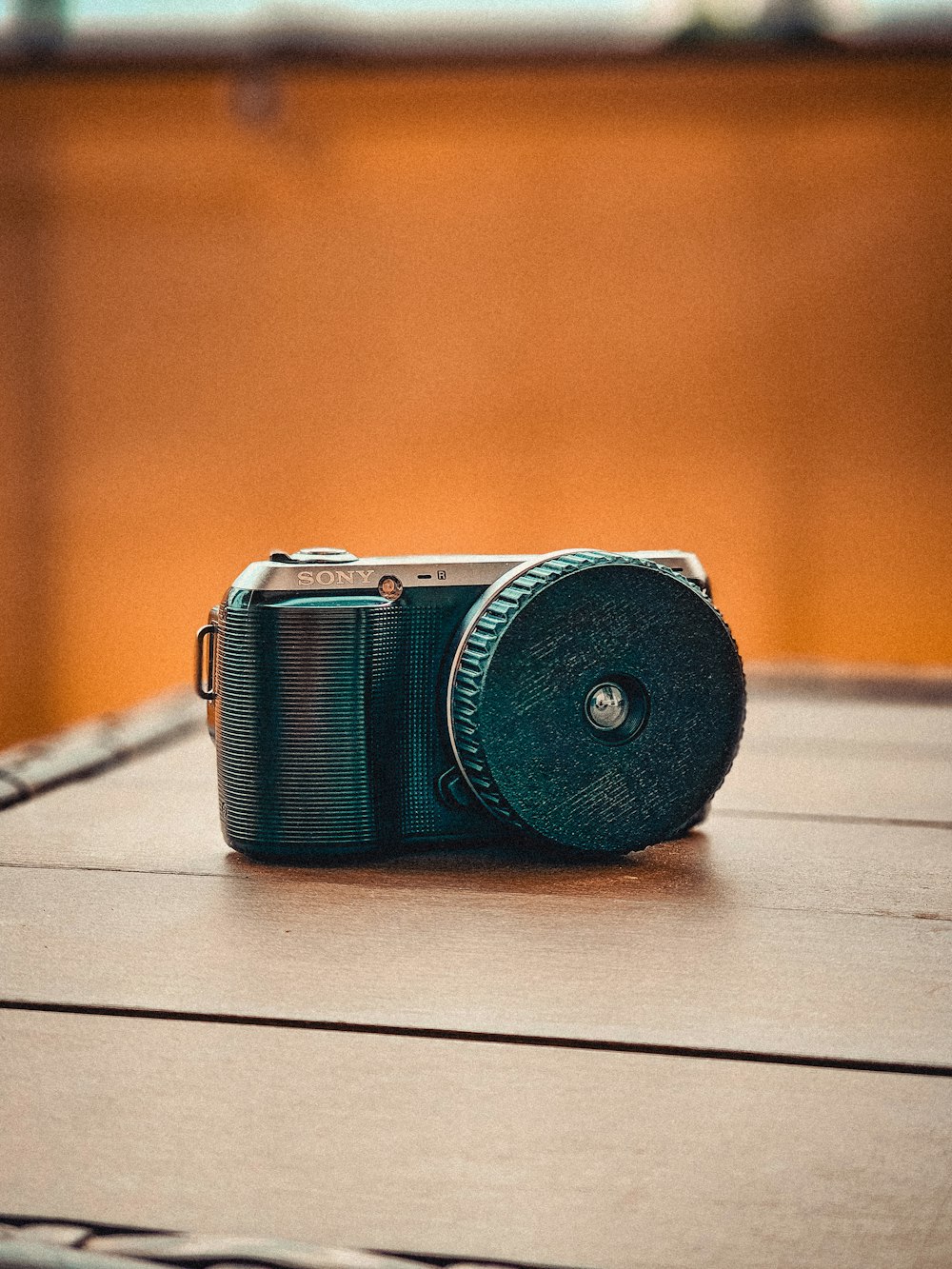 a camera sitting on top of a wooden table