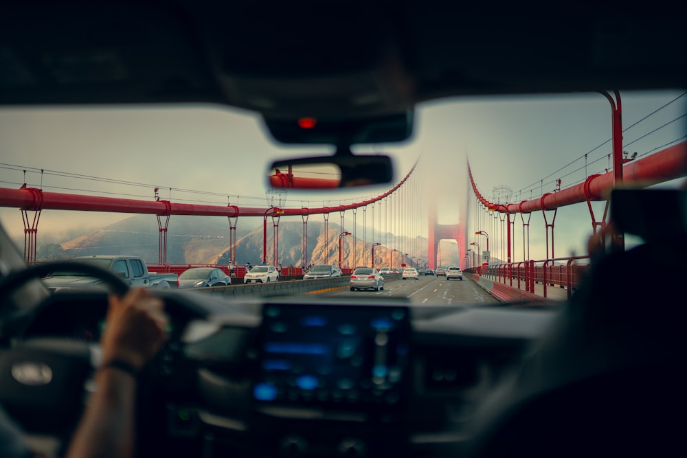 a view of the golden gate bridge from inside a car