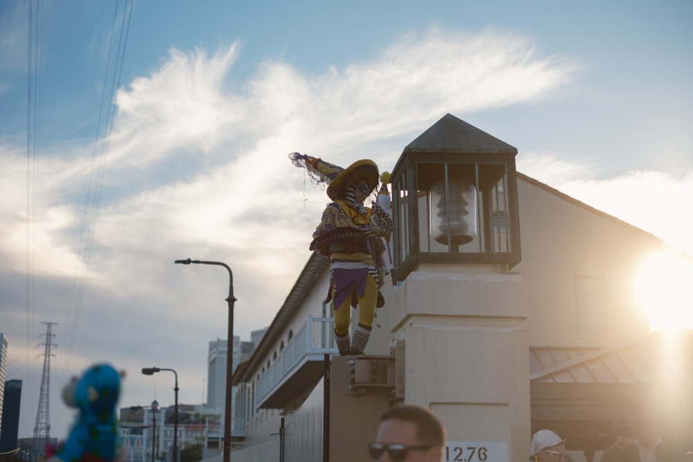 a person on top of a building with a kite