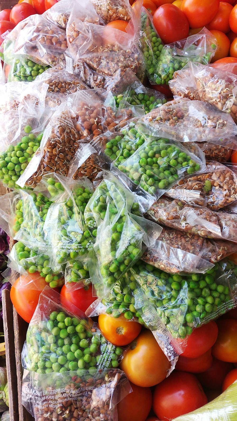 a pile of bags filled with lots of different types of vegetables