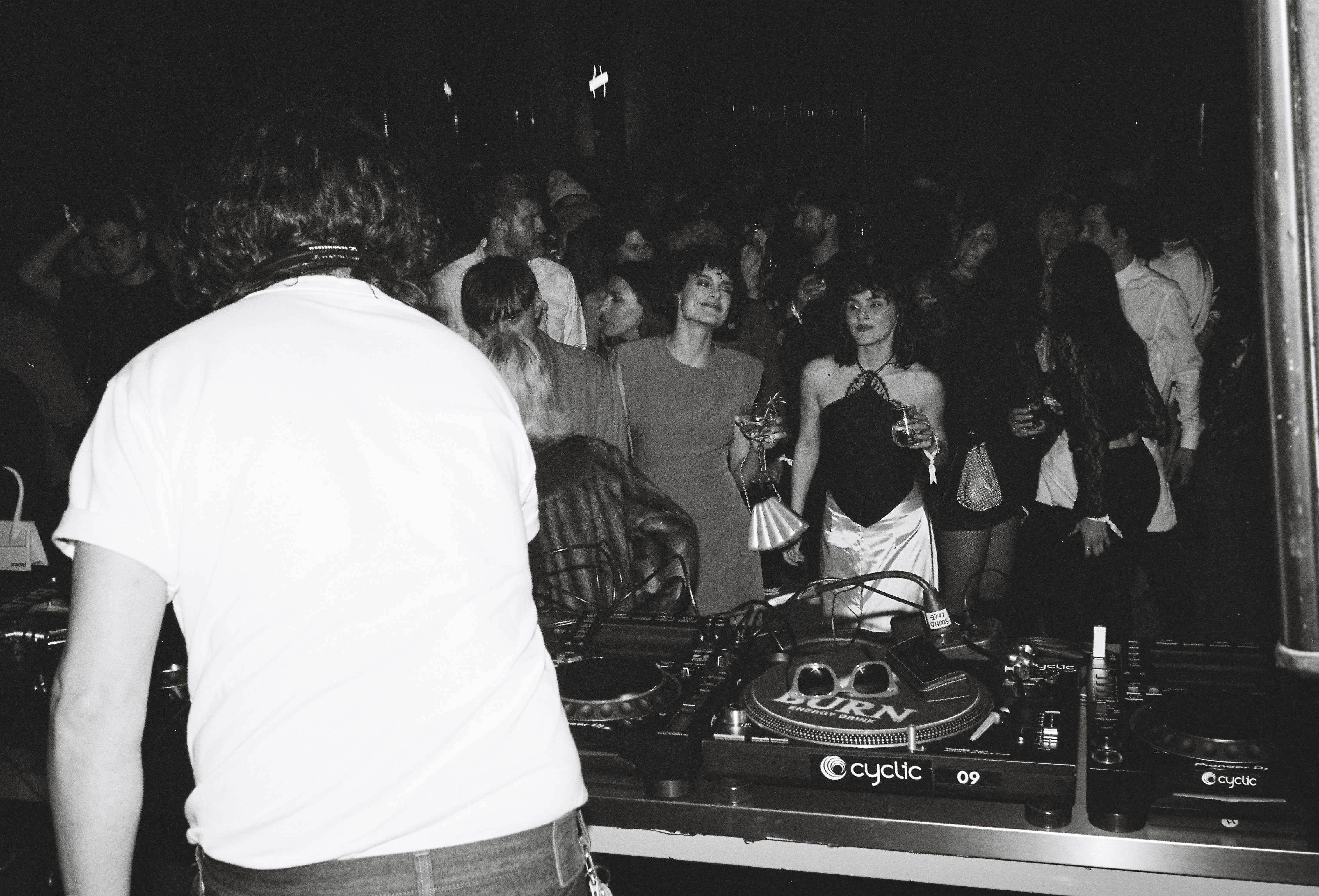 a dj mixing in front of a crowd of people