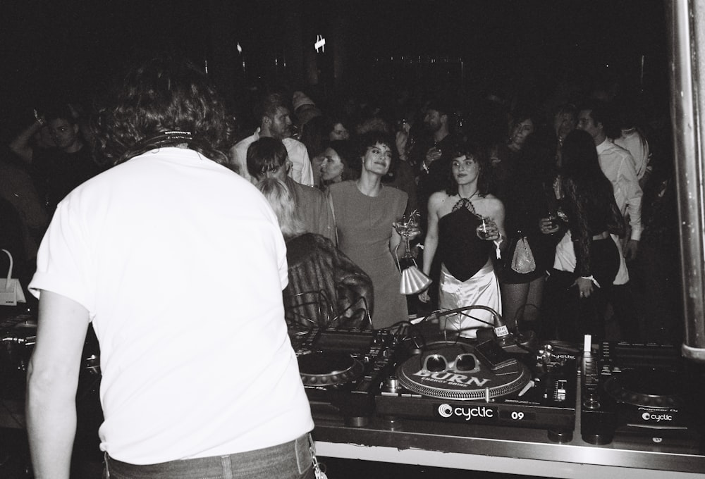 a dj mixing in front of a crowd of people