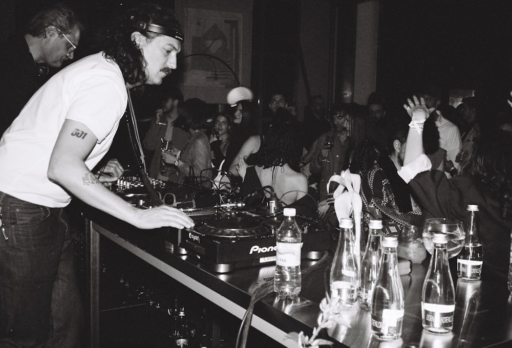 a dj mixing in front of a crowd of people