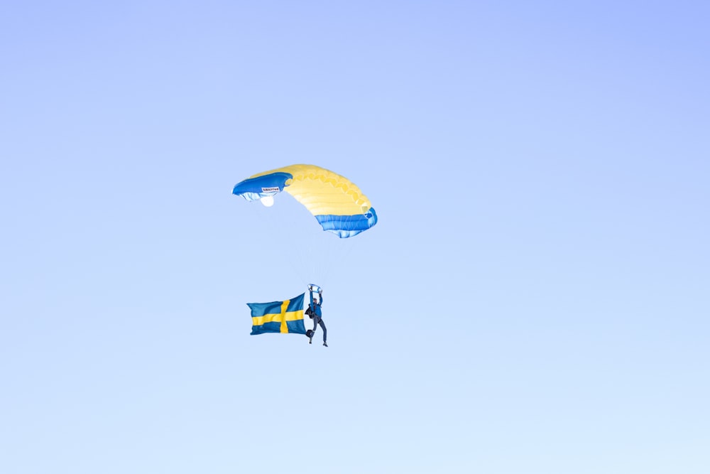 two kites flying in the sky with a swedish flag